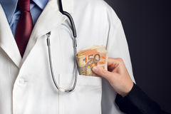 corruption-health-care-industry-doctor-receivening-large-amount-euro-banknotes-as-bribe-46295582.jpg